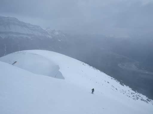 Looking back at Vern snowshoeing up steep slope